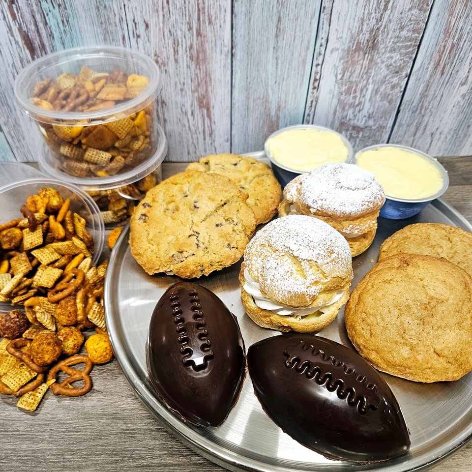 As many of you know, we spent last weekend up in Green Bay selling bakery during the 2025 NFL Draft at Lambeau! It was such an incredible experience with many memories created, new friends made and tons of stories to share. Truly a once in a lifetime opportunity! We're still on cloud 9 and yet in dire need of many more naps to make up for the loss of sleep the past two weeks. 😴 We know many of you couldn't (or didn't want to) make it up to GB so we are bringing the Draft to you this weekend!
🏈NFL Draft Menu:
Classic Cream Puff, Lemon Raspberry Mini Cheesecake, Football PB Cup, Chocolate Chip Cookie, GF/DF Snickerdoodle Cookie and Better Cheddar Snack Mix.
We mustn't forget the rest of our weekend menu though! We've restocked some fan favorites like granola and candied nuts but we also have some new items to check out as well.
Muffins: Blueberry Streusel, Cinnamon Streusel
Cheesecake: Vanilla Mini, Snickers Brownie Slice
Breakfast: Bacon Cheddar Scone, Chocolate Chip Banana Bread
Cookies: Chocolate Chip, Peanut Butter, Lemon, Gluten/Dairy/Soy Free Snickerdoodle & Gluten/Dairy Free Chocolate Chip
Cupcakes: Triple Chocolate, Vanilla, Carrot, Raspberry Cheesecake, Chocolate Mint, Caramel Macchiato, Allergen Friendly
Macarons: Earl Grey Blackberry, Orange, Godiva Chocolate
Bars: Cookie Butter S'mores Brownie, Key Lime Bar
Parfait: Orange Dreamsicle
Quiche: Chicken Bacon Ranch, Zucchini Corn Feta, Jalapeno Cheddar Brat
Other Treats: Caramel Apple Chex Mix, Candies Nuts
Granola: Cinnamon Pecan, Cherry Almond
Dog & Cat Treats