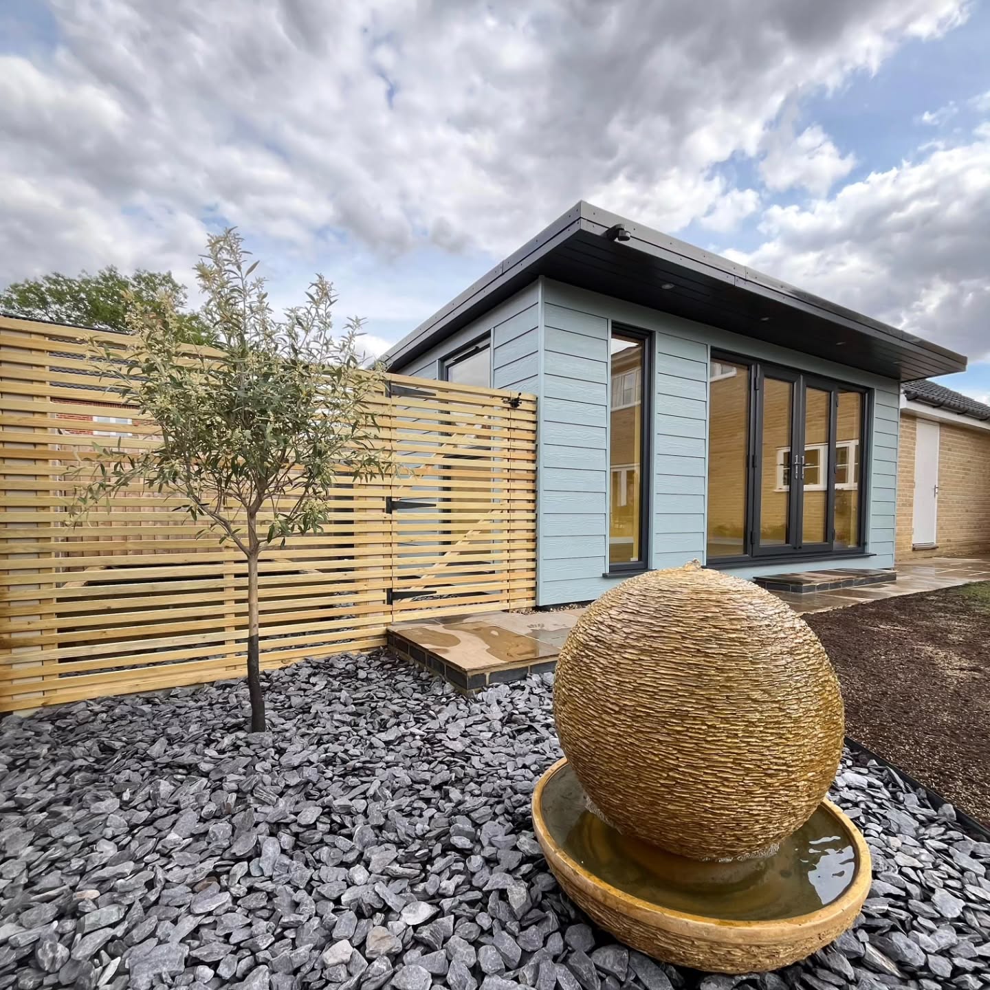 The Mattishall Job, done! 5x3m garden room with a few landscaping bits, including...
✅️ Sandstone paving and entrance step
✅️ Slatted screen fencing and bespoke gates
✅️ Raised planters for herb garden
✅️ Slate water feature area
Air conditioning being fitted in a few days time ☃️☀️ Tidy work from the team as always!
Get in touch if you'd like us to create you something similar! 2025 diary is now full. 2026 is open for business 📆
#readgardenrooms #GardenRoom #gardenbuilding #bespokebuilding #landscaping #norfolk #Suffolk #artroom #musicroom #HomeGym #homeoffice #hybridworking #annexe