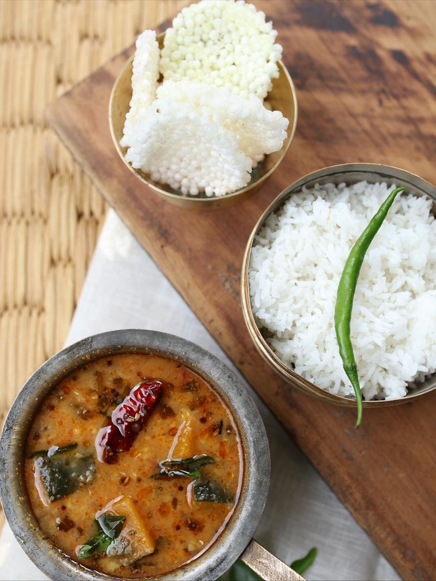 Today I was looking for a pumpkin for my daal and realised there was a severe shortage of pumpkins because of Halloween.
Just made me think what will happen all those thousands of carved pumpkins across the country once Halloween is done.
Most of them end up in the bin sadly adding to the alarming amounts of food waste that’s already happening.
So, I decided to share a vegan recipe of my mom that I really enjoy eating and it is very comforting for cold evenings.
Gummadikaya Pulusu (pumpkin stew with tamarind and Jaggery)
Pumpkin -cut into 1.5 inch chunks - 400gm
Green chillies - 2 slit
Onions - chopped - 200gm
Chopped tomatoes - 100gm (traditionally tomatoes are not used but I always liked it with tomatoes as they add more flavour and consistency)
Curry Leaves - 1 sprig
Brown Mustard seeds - 1 tsp
Cumin seeds - 1/2 tsp
Tamarind pulp - 4 tbsp
Jaggery/ brown sugar-2 tsp
Coriander powder - 2tsp
Kashmiri chili powder - 1/2 tsp
Oil- 100ml
Salt - to taste
Coriander leaves - chopped - 1 tsp
Method
Pre heat the oven to 180 degrees and roast your pumpkin with some oil and salt for approximately 15 minutes or till pumpkin is about 80% cooked.
While pumpkin is getting roasted in the oven start with the sauce
Heat oil. Add mustard seeds and cumin seeds ( make sure that the heat is on medium and oil is not too hot so the seeds don’t burn)
Once you hear mustard seeds pop add green chillies, curry leaves and onions.
Add a bit of salt and cook till onions turn slightly golden brown.
Add tomatoes and a splash of water and keep cooking on medium heat with a lid on for 5-6 minutes till tomatoes breakdown. Keep adding water little at a time to keep the consistency of the sauce.
Add coriander powder and chilli powder, mix well and add tamarind pulp.
Cook for another couple of minutes and add sugar or jaggery.
By now the pumpkin should be ready. Take them out of the oven and add to sauce. Simmer for another 3-4 minutes.
Check and adjust the seasoning
Garnish with chopped coriander leaves and eat it along with some rice or flat breads.
Give it a go and make most of your pumpkin as our friends at Real Junk Food Project say - Feed Bellies not Bins!