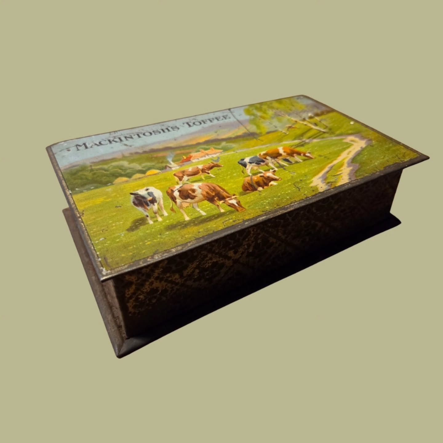 Mackintosh’s – Brand History
Founded in 1890 in Halifax, Yorkshire, Mackintosh’s quickly became one of Britain’s most celebrated confectionery manufacturers, best known for iconic sweets such as Toffee de Luxe and Quality Street.
The company built its reputation on quality ingredients, innovative packaging and beautifully illustrated tins that were designed to be reused in the home long after the sweets were gone.
During the early 20th century, Mackintosh’s invested heavily in high-quality lithographed tin designs, often featuring nostalgic rural scenes, domestic imagery and idealised British landscapes. These tins were intended not only as packaging, but as keepsakes—objects that reflected comfort, prosperity and tradition. Today, original Mackintosh’s tins are highly collectible, prized for their artwork, craftsmanship and strong connection to Britain’s confectionery and social history. #stufftoyouandme